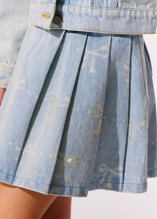 Model Wearing Lola And The Boys Sparkle Bows Denim Pleated Skirt